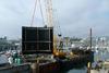 Sub Marine Services' spud leg pontoon barge, with their own 80 ton IHI crawler crane on board, installing one of the inner gates at Sutton Harbour.