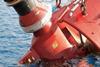 A Hydrex diver accompanies a thruster removed from an offshore crane barge off the coast of Gabon.