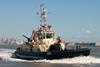 Svitzer Stanlow at speed, showing her low foredeck and powerful towing winch.