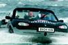 Richard Branson knocks six hours off the record for crossing the English Channel in a car boat.