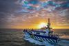 The image shows a Tidal Transit CTV on the water at sunset