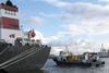 A Hydrex workboat with equipment is seen next to a tanker in Antwerp