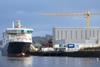 Ship next to warehouse and crane