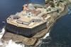 The image shows an overhead shot of the Santa Cruz Lighthouse, located on Santa Cruz Fortress at Guanabara Bay, Brazil