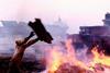 Workers burning rubbish and waste oil on the beach of the scrap yard Alang in India. Picture courtesy of Engel/Greenpeace.