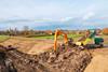 The image shows electric equipment being used during the dyke reinforcement project commissioned by Rivierenland Water Board.