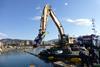 The dredging bucket was installed on a CAT excavator that worked from a floating pontoon