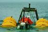 The wreck of the Pamela S on tow into Tenby Harbour supported on lifting bags.