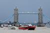 Barges at close quarters as they clear Tower Bridge.