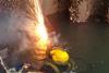 A Seawork Marine Services diver performs underwater burning work at a container port.