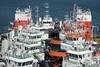 A view from the bridge of the heavy lift ship Fjell shows 16 tugs on the cargo deck.