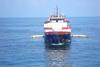 A sweeping arm system fitted to a commercial vessel collects oil in the Gulf of Mexico.