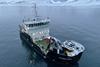 OV Bøkfjord at sea with snow-covered mountains behind