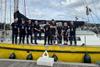 The image shows the NSSLGlobal team with the crew onboard the Ocean Youth Trust North’s yacht James Cook
