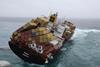 Rena losing containers as heavy swells wash her deck on the starboard side. Image: Mark Alen.