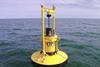 The buoy supports an extended heave plate to control the buoy motions and inside the buoy is a float that moves up and down with the wave motion
