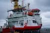 SMB James Caird IV is seen on the quay with mothership HMS Protector alongside.