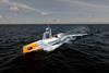 The image shows the Oceanus 12 XLR USV on the water