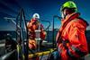 The image shows NextGeo workers onboard a vessel