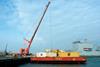 Containers are lifted from the shuttle barge at Portland Docks.  Photo by Dorset Media Service