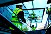 One of 170 glass panels which will protect the hull of ss Great Britain from further corrosion is lowered into position.