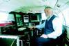 Atlantic Reconnaissance Technical Director Roger Stockham at the surveillance console he designed for the MCA.