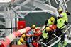 The exercise scenario portrayed a severe occupational accident involving injuries to extremities and the head, which made prompt medical help necessary