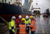 Busy harbour workers planning in the rain