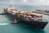 The image shows Svitzer tugs guiding a container ship into port