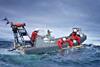 The image shows a team at sea deploying a Teledyne Gavia AUV