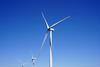 The image shows an up close picture of some offshore wind turbines