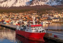 Fishing vessel with mountains behind