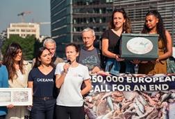 The image shows Oceana representatives taking the petition to the EU