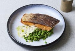Crispy salmon with beurre blanc, crushed peas and parsley oil using salmon supplied by BAP-certified producer Hiddenfjord