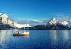 Fishing boat and Reine Village, Lofoten Islands, Norway