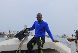 Member of Project Recon sat on board a boat with a recovered echosounder buoy