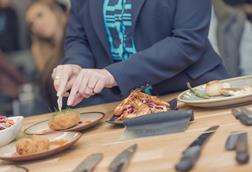 Someone cutting into seafood at the UK Seafood School in Grimsby