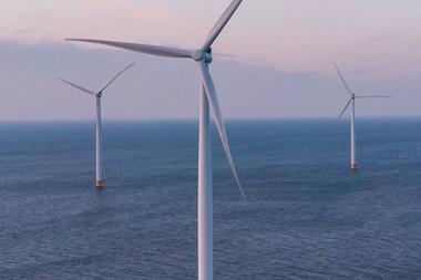 The image shows offshore wind turbines