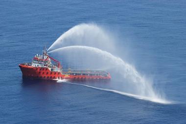 A service vessel at sea spraying water