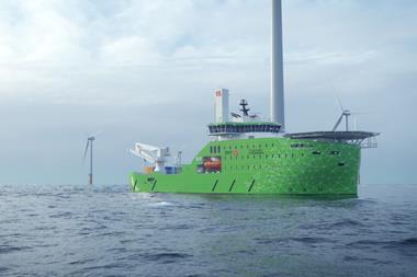 A Bibby Marine offshore service vessel on the water with wind turbines in the background
