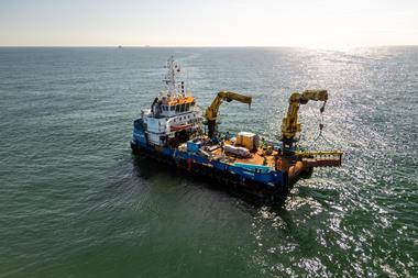 The image shows Jan De Nul's Voe Vanguard Multicat vessel at sea during the project