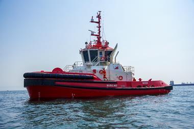 A red and white tugboat named 'BOSS' at sea