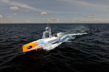 The image shows the Oceanus 12 XLR USV on the water