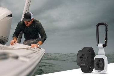 e image shows a man onboard a vessel with a cut out image of the Garmin Onboard