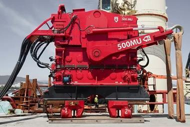 The image shows a vibro hammer on the quayside