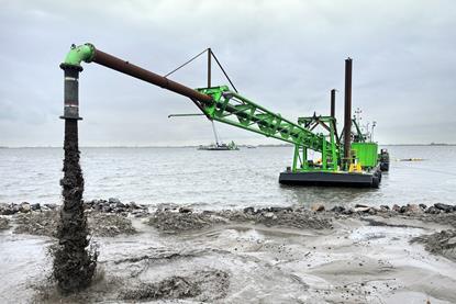 DEME dredger at work reinforcing the dyke at Marken