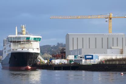 Ship next to warehouse and crane