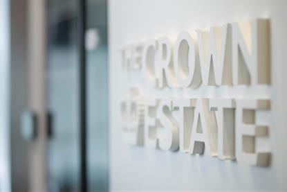 The image shows a wall emblazoned with The Crown Estate