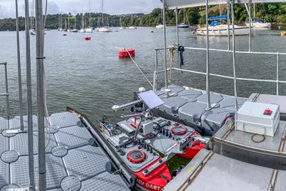 The image shows a USV docked at a centralised hub during the project