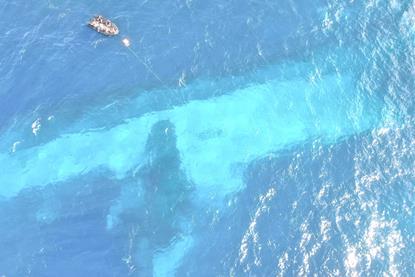 'Manawanui' is visible submerged on the reef off Samoa (New Zealand Navy)